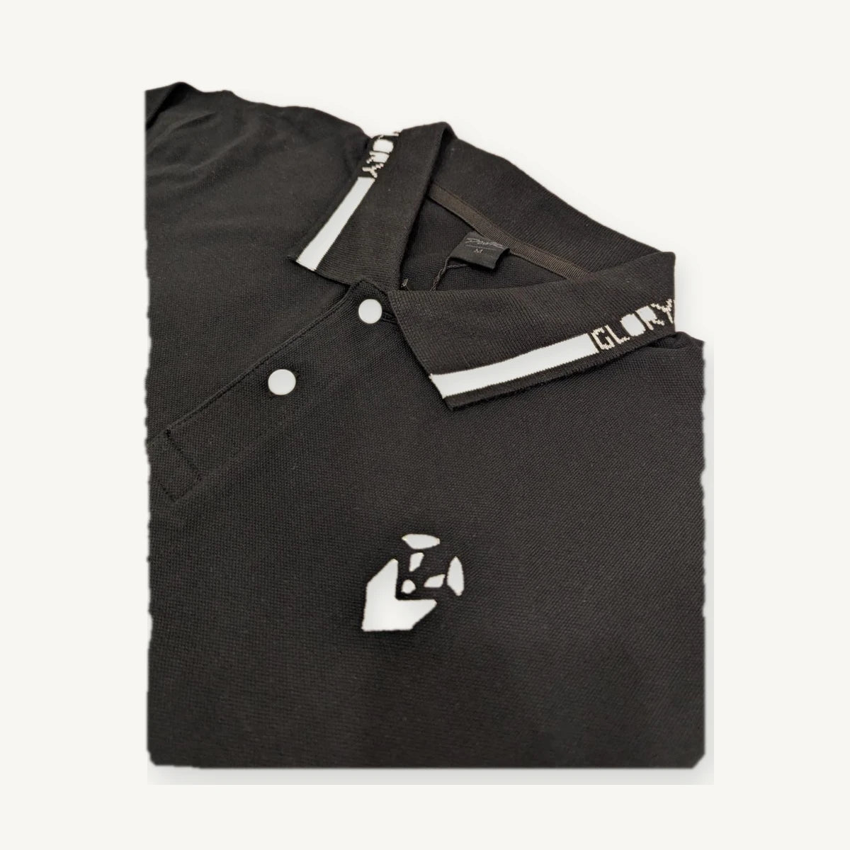 Black knit polo with embroidered branding and custom collar detail produced through our manufacturing network